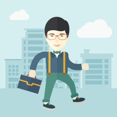 Young man walking through the city street with his briefcase.