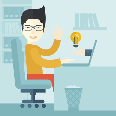 Asian guy working inside his office.
