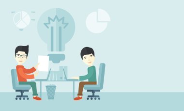 Two japanese businessmen sitting working together.