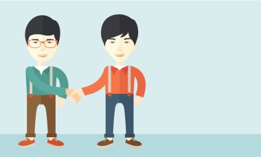 Two asian guys happily handshaking.
