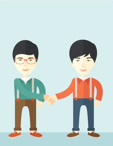 Dos asiático chicos felizmente handshaking . — Vector de stock