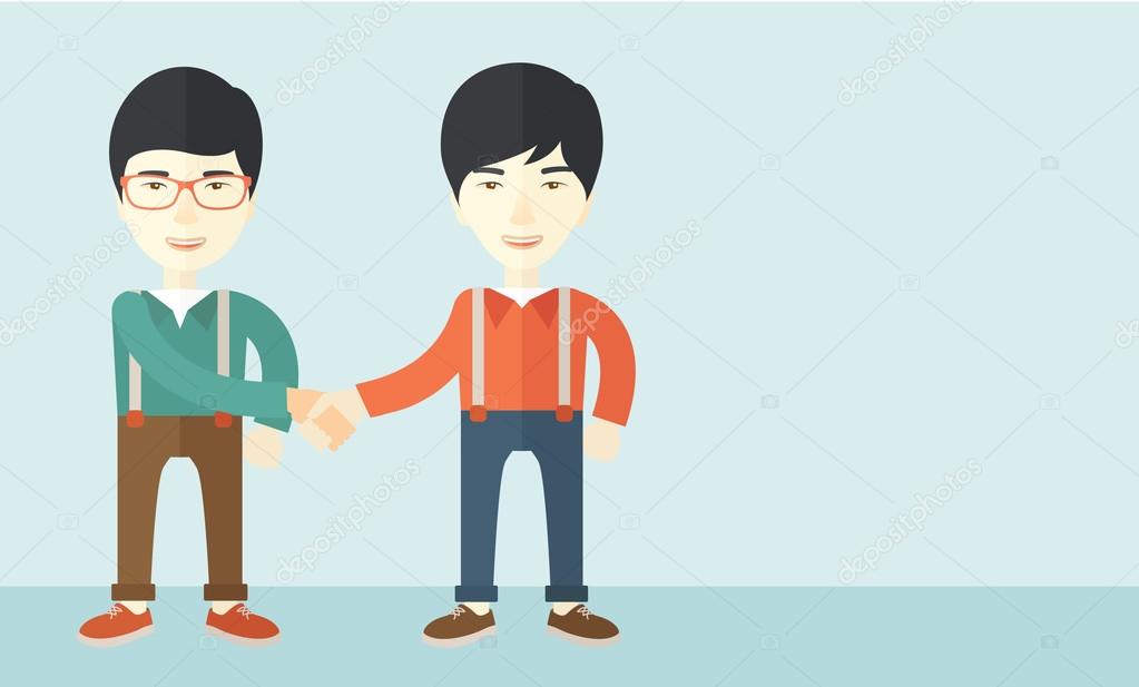 Two asian guys happily handshaking.