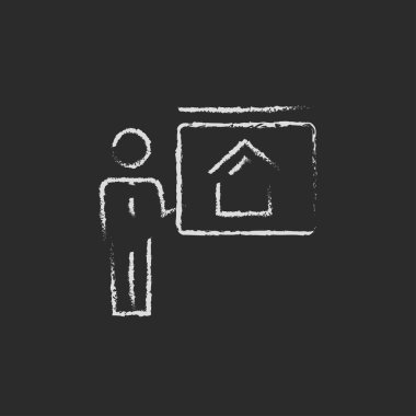 Real estate agent showing the house icon drawn in chalk. clipart