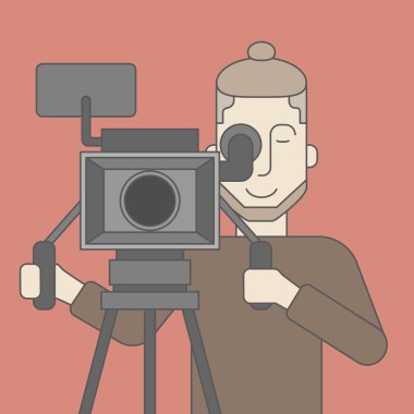 Cameraman with beard looking through movie camera