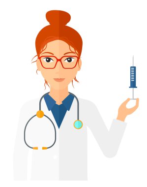 Doktor elinde şırınga tutuyor..