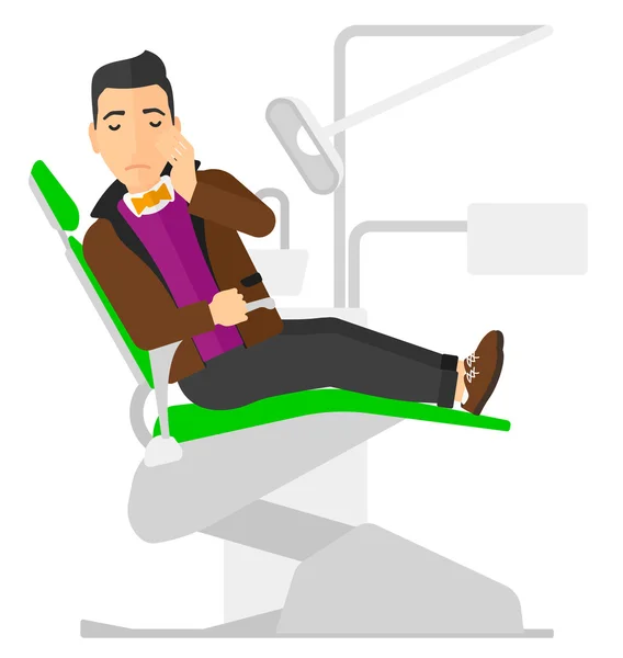 Hombre sufriendo en silla dental . — Vector de stock