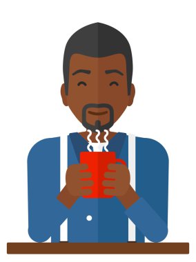 Fincan kahve ile oturan adam.