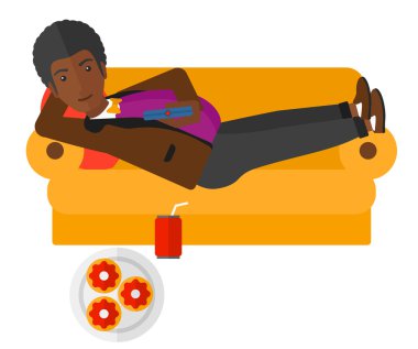Man lying on sofa with junk food.