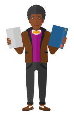 Man choosing between book and tablet.