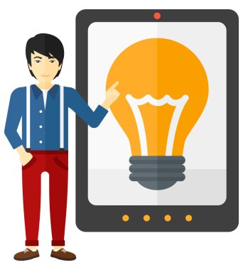 Man pointing at tablet computer with light bulb on screen.