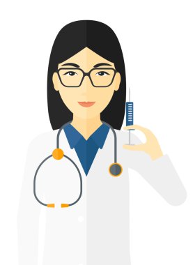 Doktor elinde şırınga tutuyor..