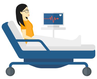 Patient lying in bed with heart monitor.