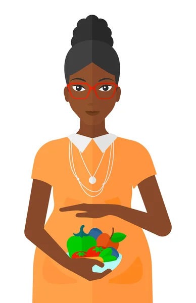 Femme enceinte avec des légumes . — Image vectorielle