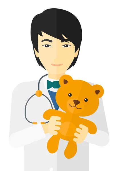 Kinderarzt hält Teddybär. — Stockvektor