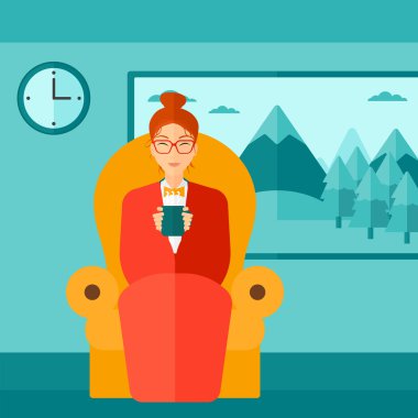 Woman sitting in chair with cup of tea.