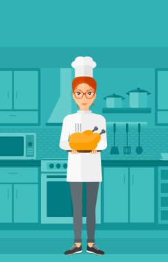 Woman holding roasted chicken.