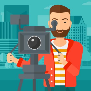 Cameraman with movie camera on a tripod.