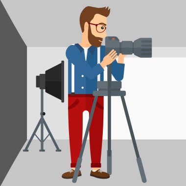 Photographer working with camera on a tripod.