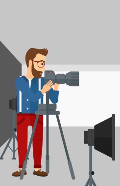 Photographer working with camera on a tripod.
