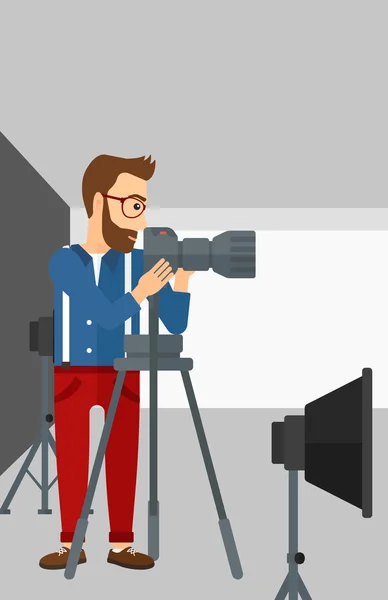 Photographer working with camera on a tripod. — Stock Vector