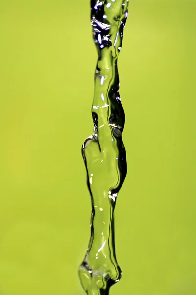 Water Pouring, Yellow Background — Stock Photo, Image