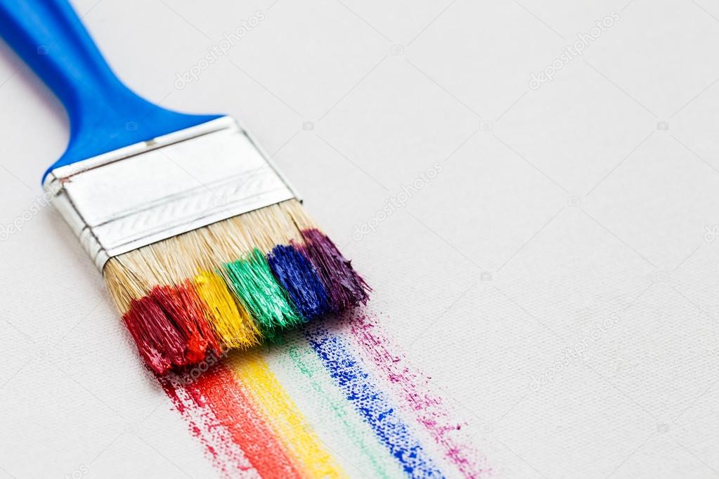 Paintbrush and multicolor rainbow brush strokes on white artist Stock