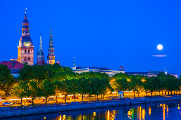 Old Town of Riga with reflection in Daugava River at night. Latvia