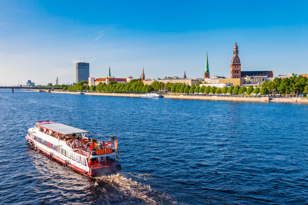 Walking ship floats the river Daugava, panoramic view of Riga
