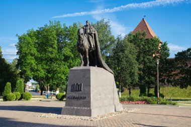 View of Monument to Grand Duke Gedimin on a horse, Lida Castle in background. Lida, Belarus. clipart