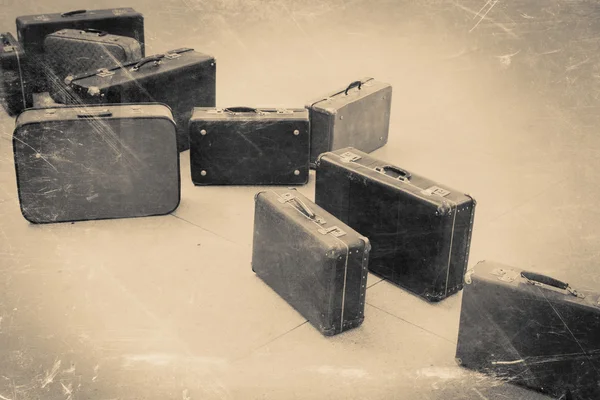 Group of vintage suitcase on tiled floor, retro stylized — Stock Photo, Image