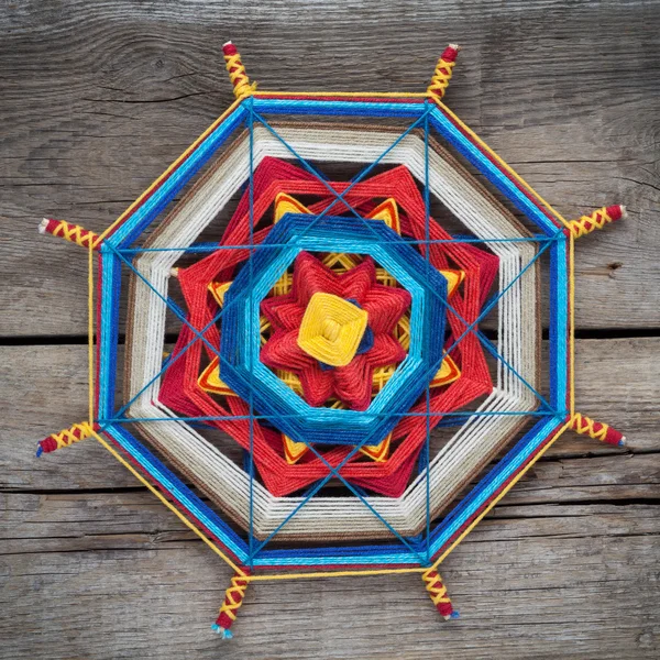 Knitted mandala on wooden plank — Stock Photo, Image