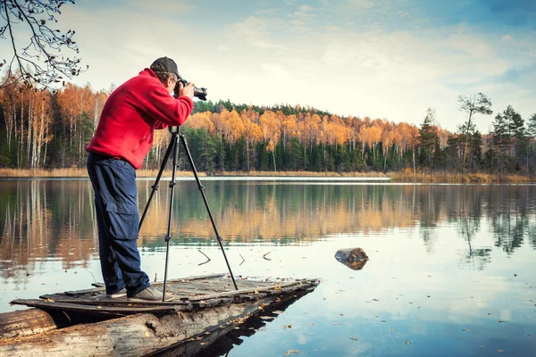 Man photographer with camera on a pier — Stock Photo, Image