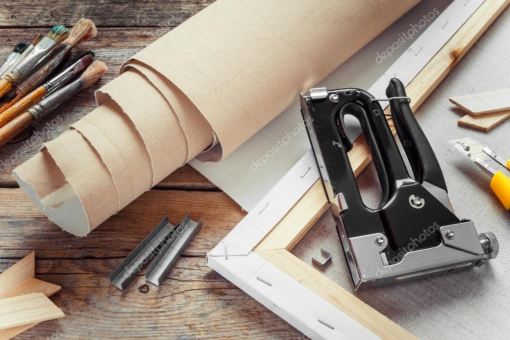 Artist canvas in roll, canvas stretcher, staple gun and paintbru — Stock Photo © ChamilleWhite