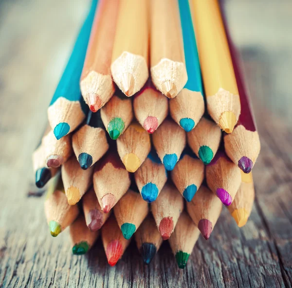 Colored Drawing Pencils on old desk. Vintage stylized image. — Stock Photo, Image