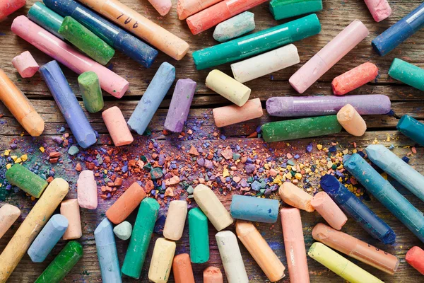 Collection of rainbow colored pastel crayons with pigment dust o — Stock Photo, Image