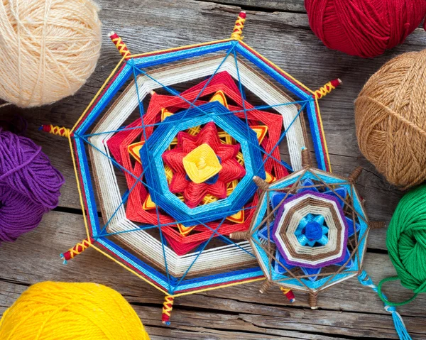 Two knitted tibetan mandala from threads and yarn on wooden rust — Stock Photo, Image