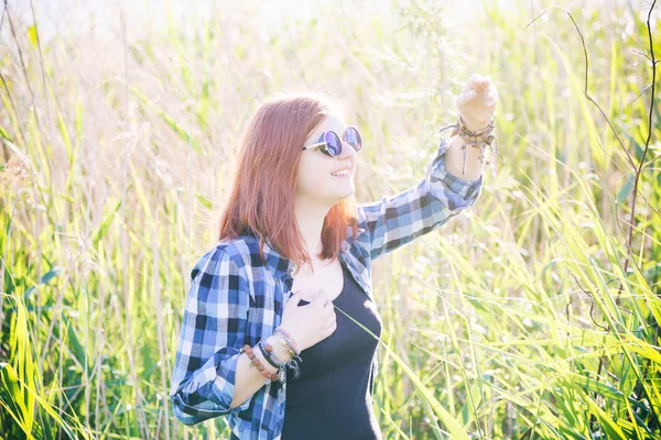 Happy beautiful young woman on summer meadow in tall grass — Stock Photo, Image