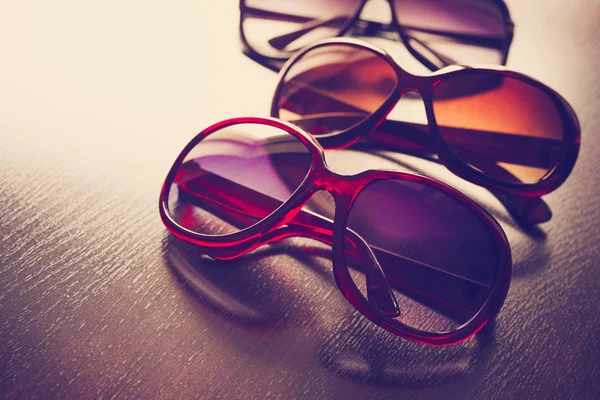 Fashionable sunglasses on desk. Vintage stylized. — Stock Photo, Image