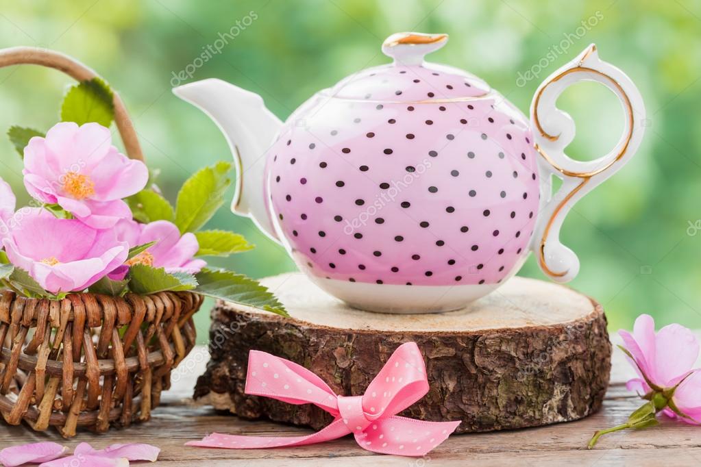 Tea kettle and basket with pink wild roses. Wedding or birthday Stock Photo  by ©ChamilleWhite 76569759