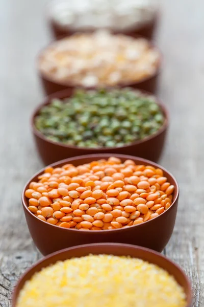 Bowls of cereal grains. Selective focus on red lentils. — Stock Photo, Image