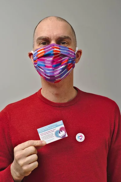 Homme Vacciné Portant Masque Facial Tenant Une Fiche Vaccination Britannique — Photo