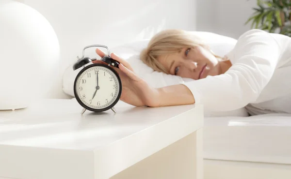 Lady has woken up by an alarm clock. eyes open — Stock Photo, Image