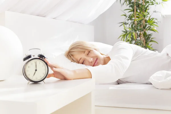 Lady has woken up by an alarm clock. eyes closed — Stock Photo, Image