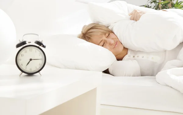Lady has woken up by an alarm clock eyes closed — Stock Photo, Image