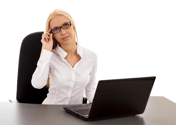 Gözlüklü güzel iş kadını masada dizüstü bilgisayar ile