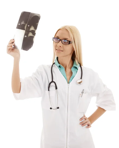 Beautiful woman doctor in glasses, considering radiograph. — Stock Photo, Image