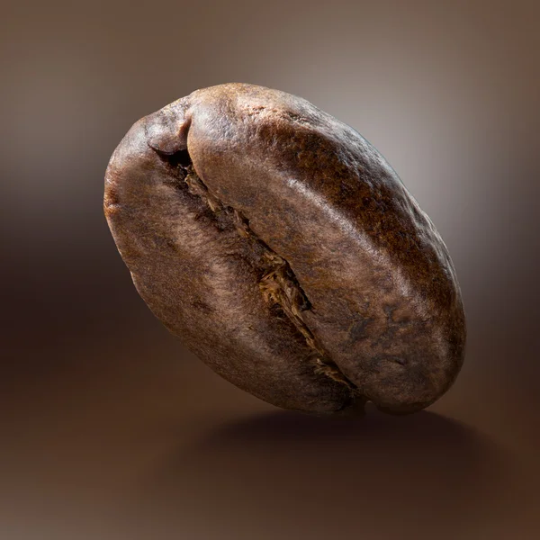 Kaffe bean på brun bakgrund — Stockfoto