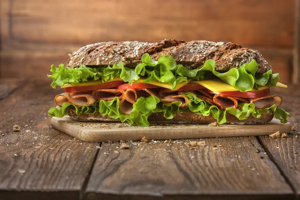 Sandwich on the wooden table — Stock Photo, Image