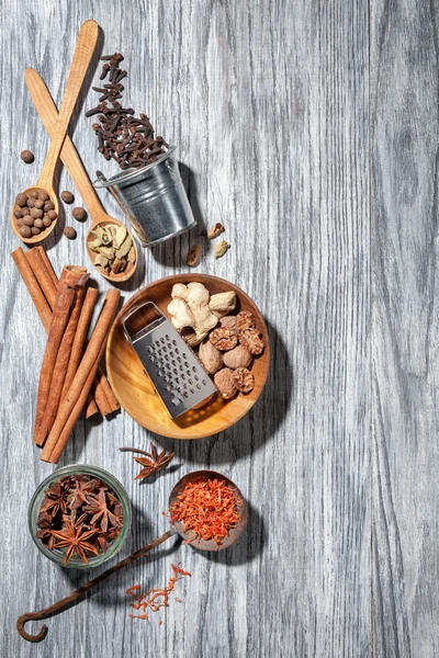 Various spices on wooden background — Stock Photo, Image
