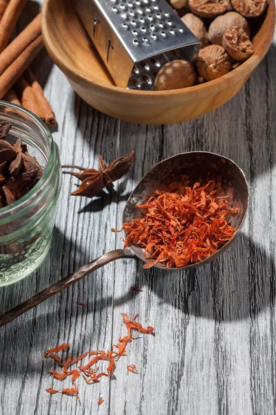 Saffron with various spices on wooden background — Stock Photo, Image